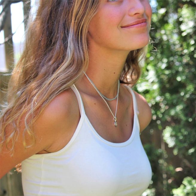 beautiful girl wearing layered veda necklaces blue topaz