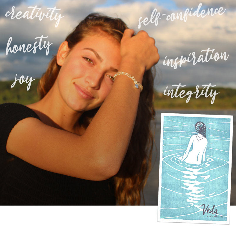 young girl wearing veda jewelry bracelet on the maine shore