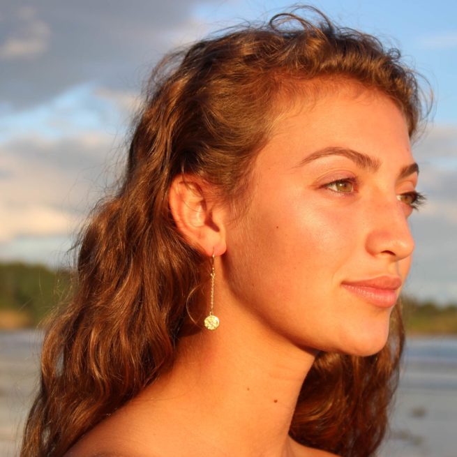 girl on a maine beach wearing veda jewelry chain earring chakra