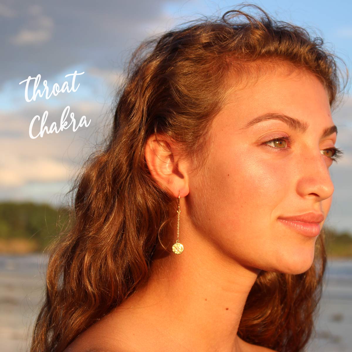 girl on maine beach wearing veda jewelry throat chakra chain earrings